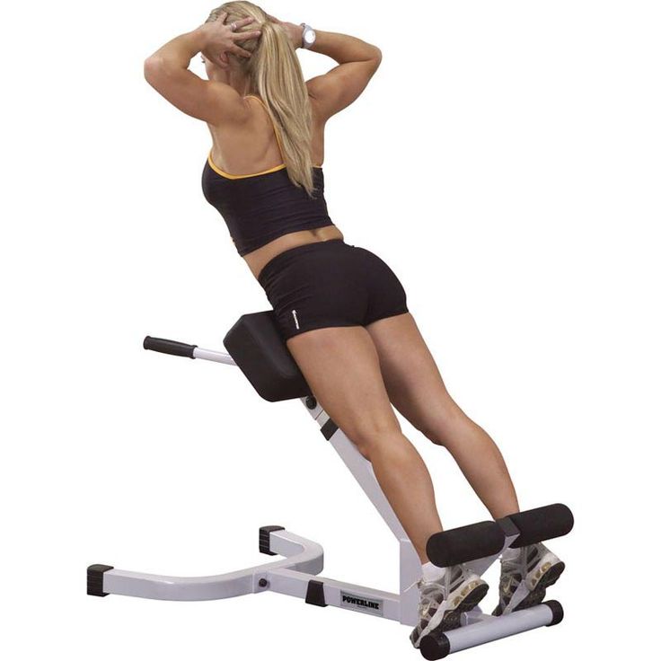 a woman is sitting on an exercise bench