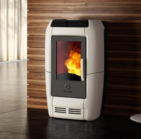 a white stove sitting on top of a wooden floor next to a wall mounted heater