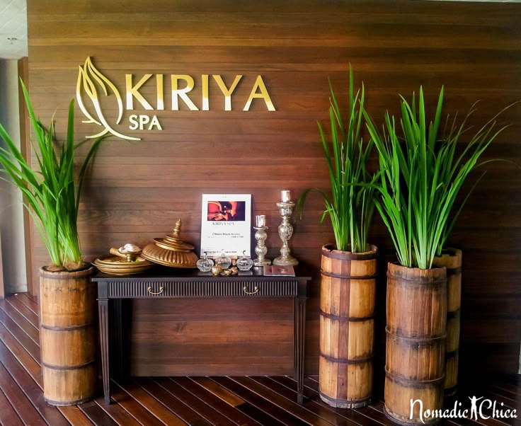 three bamboo planters are sitting in front of a sign that says kiriya spa