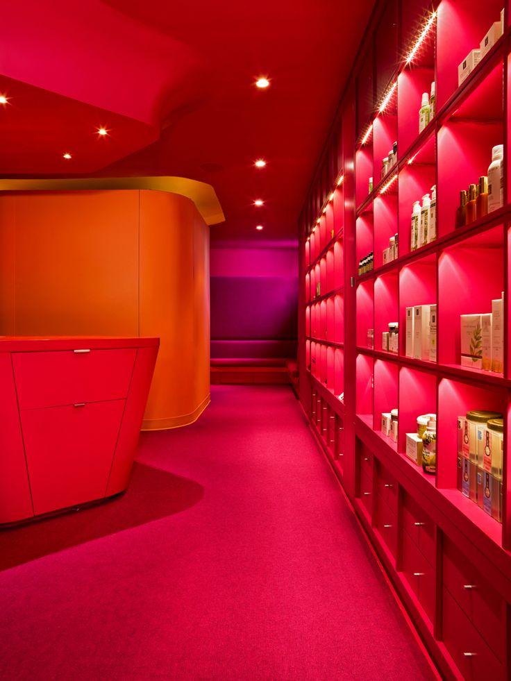 the shelves are filled with various types of items in bright pink and orange colors,