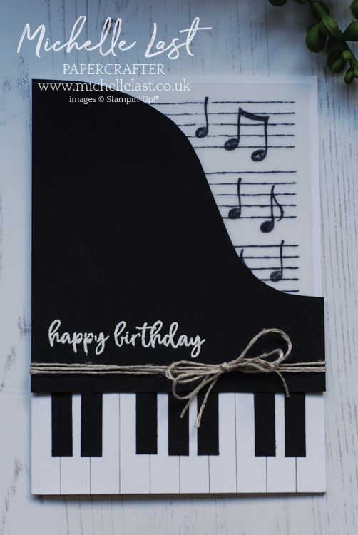 a black and white card with music notes on it, which says happy birthday next to a piano