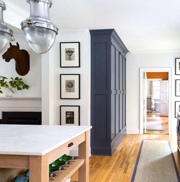 a kitchen with an island and pictures on the wall