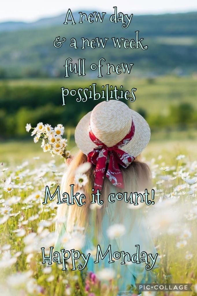 a woman in a hat and scarf walking through a field with daisies on it