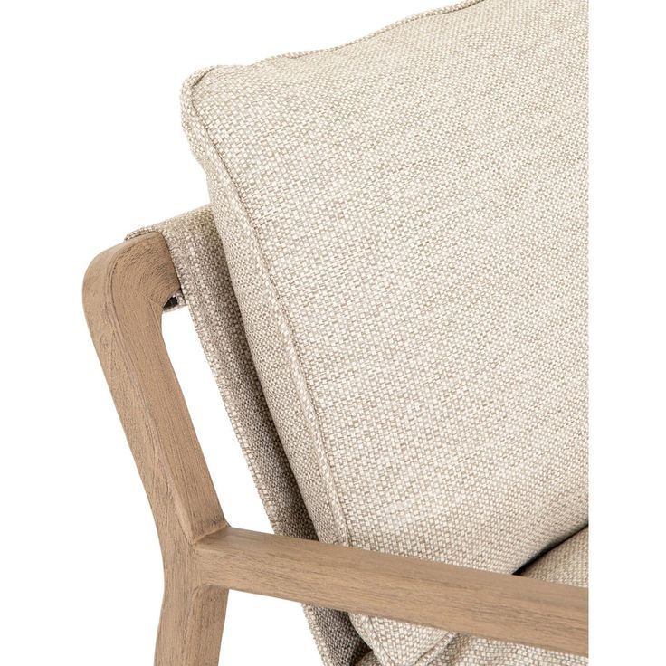 an upholstered chair with a wooden frame and beige fabric on the armrests