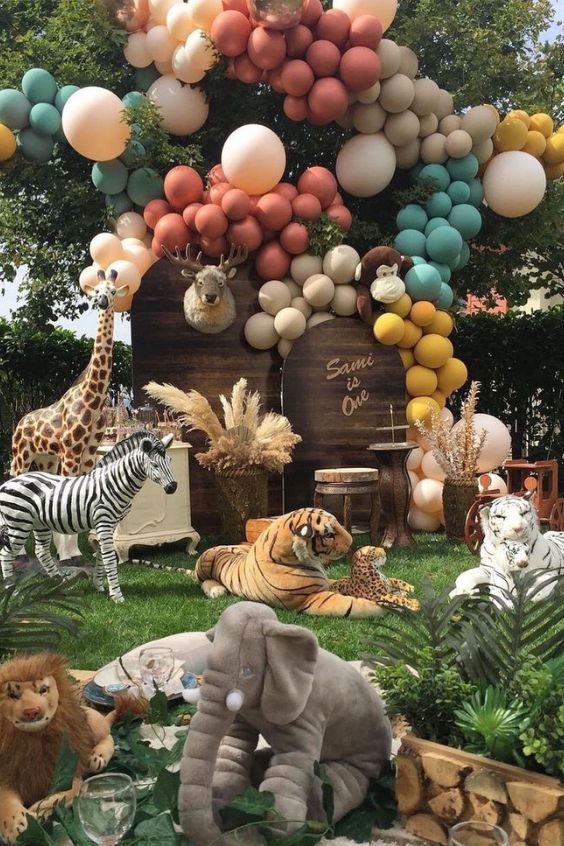 an animal themed birthday party with balloons and animals