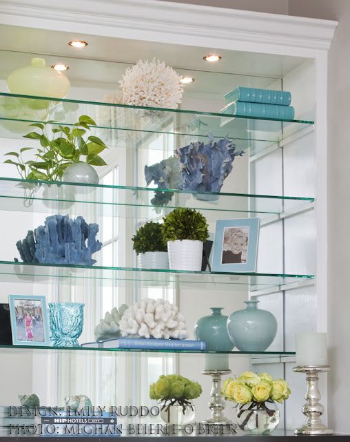 the shelves are filled with vases and other decorative items, including flowers on them