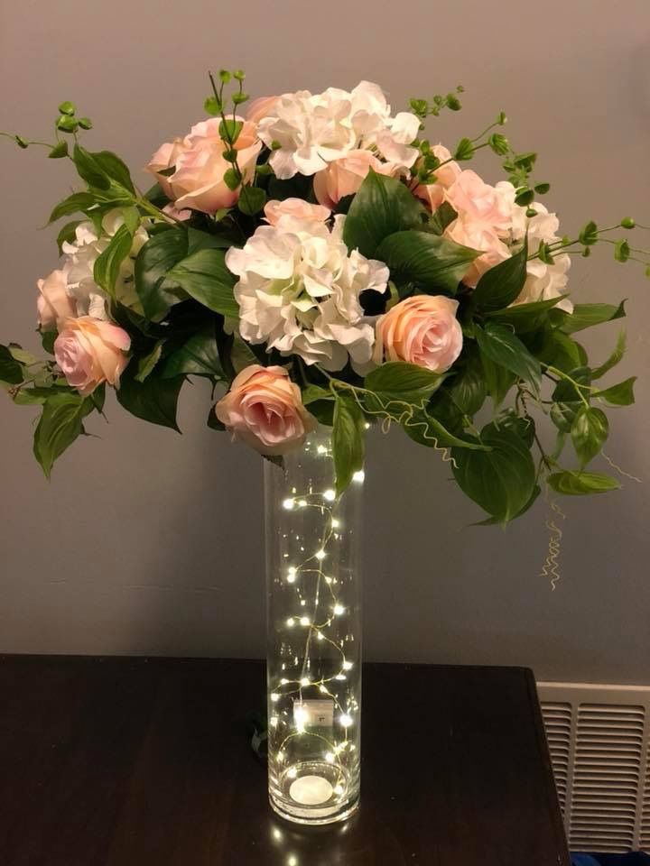 a vase filled with white and pink flowers