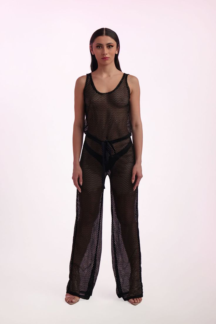 Josie Mesh RomperKey Features: Perfect for festivals and Miami club nights Sexy black mesh fabric Versatile for solo wear or layering Floor-length with a U-shape neckline Figure-defining drawstring tie at the waist Made in the USA Details: The Josie Mesh Romper is crafted from sexy black mesh, making it ideal for festivals or Miami nights. Wear it solo for a bold look or layer it for added texture. With a floor-length design, U-shape neckline, and a figure-defining drawstring tie, this romper en Black Fishnet Mesh Top For Night Out, Black Mesh Top With Mesh Back For Party, Fishnet Mesh Top For Summer Parties, Summer Party Mesh Top With Fishnet Details, Summer Party Fishnet Mesh Top, Black Mesh Top For Summer Clubbing, Black Mesh Top For Summer Evenings, Fitted Black Mesh Top For Festival, Black Sleeveless Mesh Top For Evening