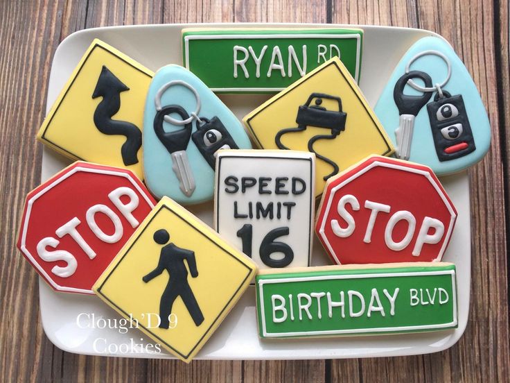 decorated cookies are arranged on a plate with street signs