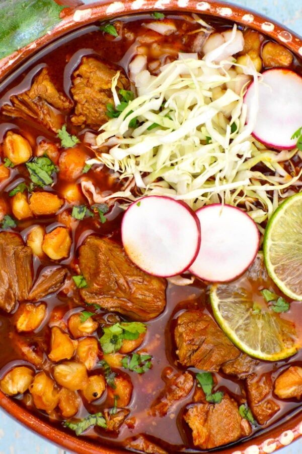 a bowl filled with meat and vegetables covered in sauce