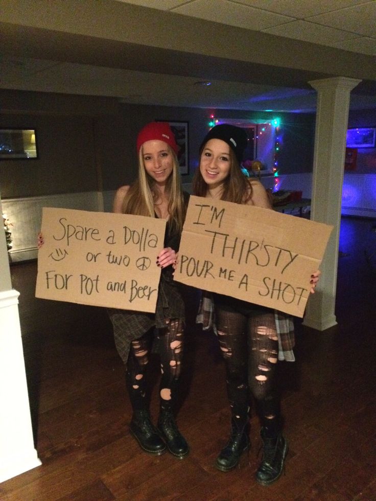 two girls holding signs that say i'm sorry to you and they are not wearing boots