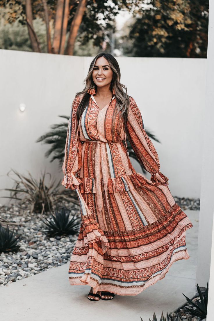 Bohemian Long Boho Dress For Fall, Fall Bohemian Long Boho Dress, Long Bohemian Boho Dress For Fall, Long-sleeved Flowy Dress With Tassels, Flowy Long Sleeve Dress With Tassels, Fall Boho Print Hippie Maxi Dress, Fall Hippie Boho Print Maxi Dress, Fall Hippie Maxi Dress With Boho Print, Bohemian Orange Maxi Dress For Fall