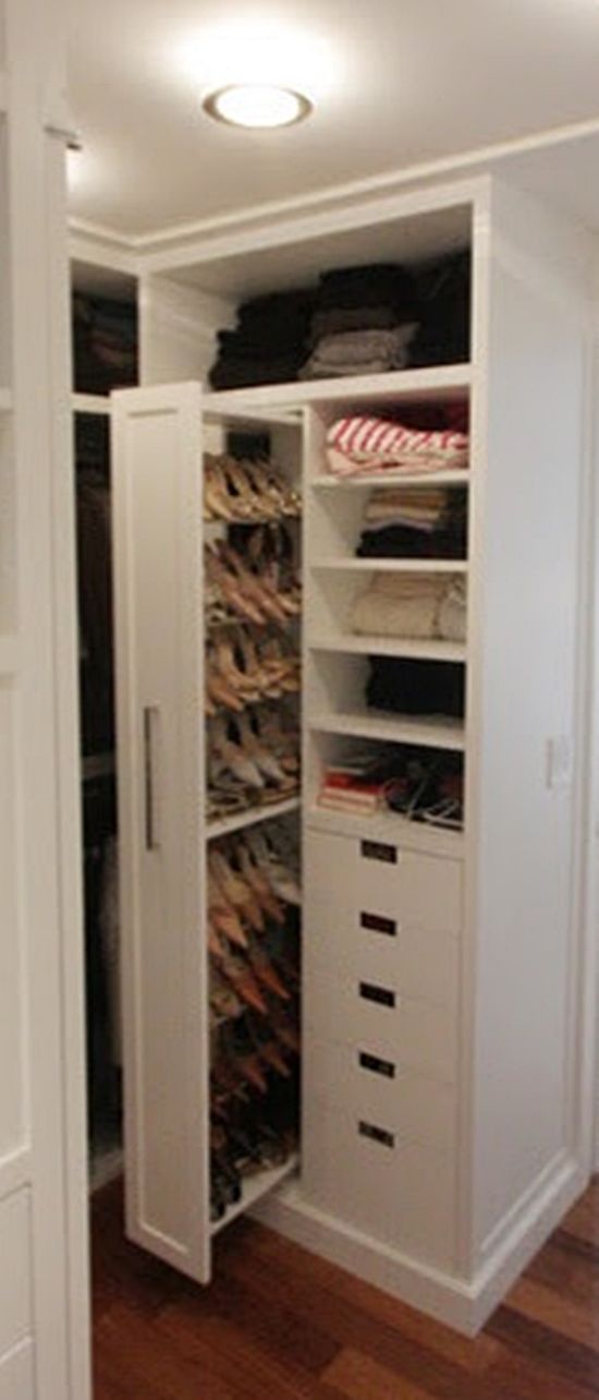 the closet is full of shoes and other items in it's white storage area