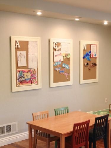 a dining room table and chairs with the words simple kids art display above it on the wall