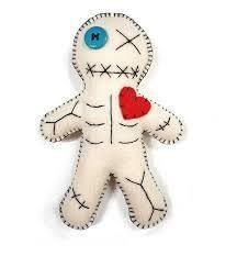 a white stuffed animal with a heart on it's chest and eye patch in the shape of a skeleton