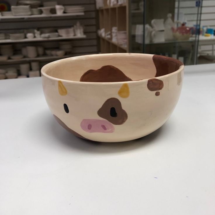 a brown and white bowl sitting on top of a counter