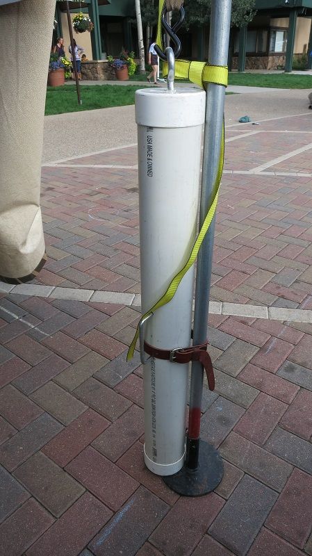 a white water heater sitting on top of a sidewalk