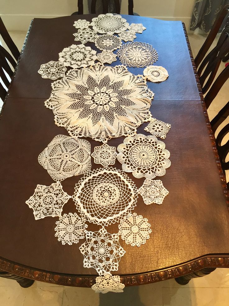 a wooden table with white doily on it