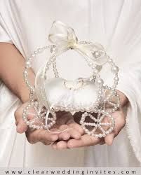 a person holding a white purse with pearls and bows on it's hands,