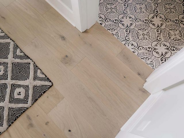 a bathroom with a black and white rug on the floor