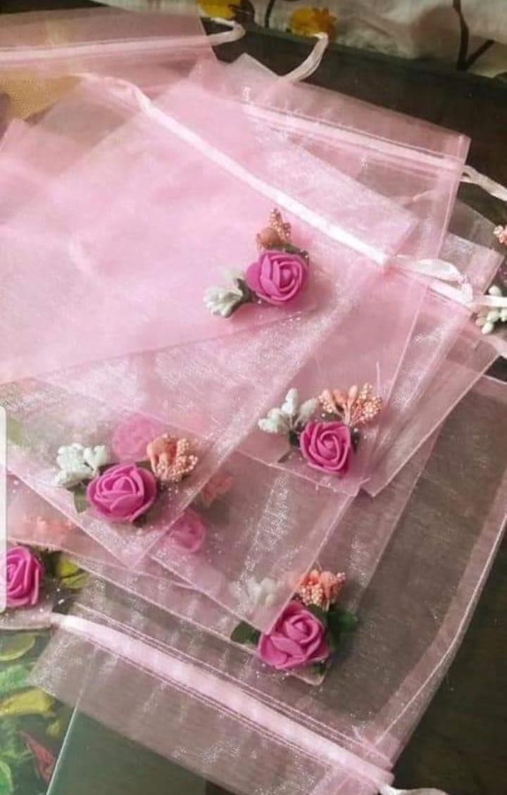 pink flowers are placed on clear plastic bags