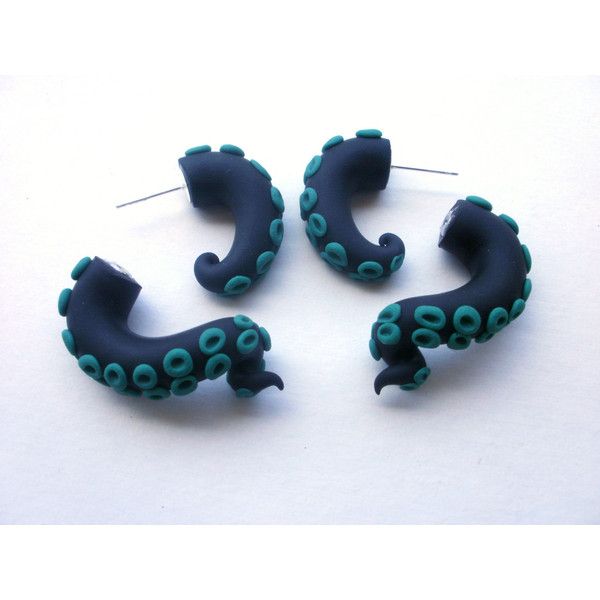 three pairs of blue and green earrings on a white surface with pins in the shape of an octopus