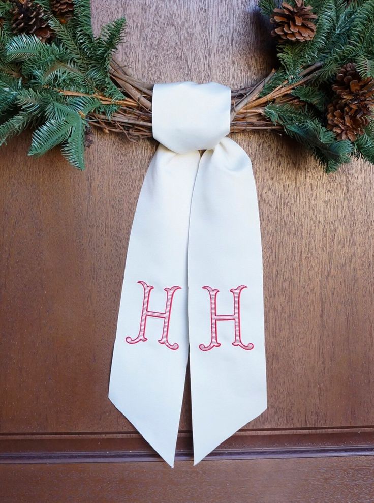 a christmas wreath with the letter h on it