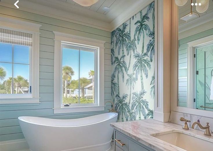 a bathroom with two sinks and a large bathtub in it's center, surrounded by palm trees