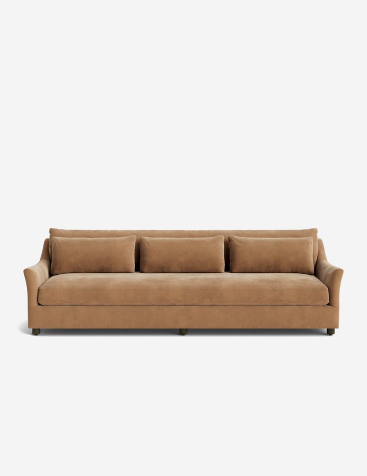 a tan couch with three pillows on it's back and one arm facing the camera