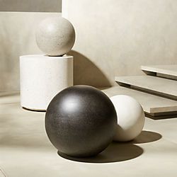 three balls sitting on top of each other in front of some steps and cement blocks