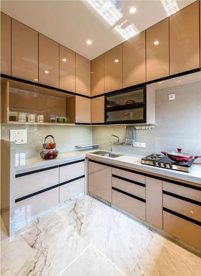 a kitchen with marble counter tops and wooden cabinets