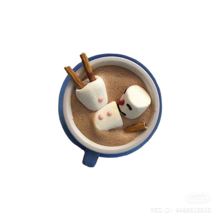 two marshmallows in a cup with cinnamon sticks sticking out of them