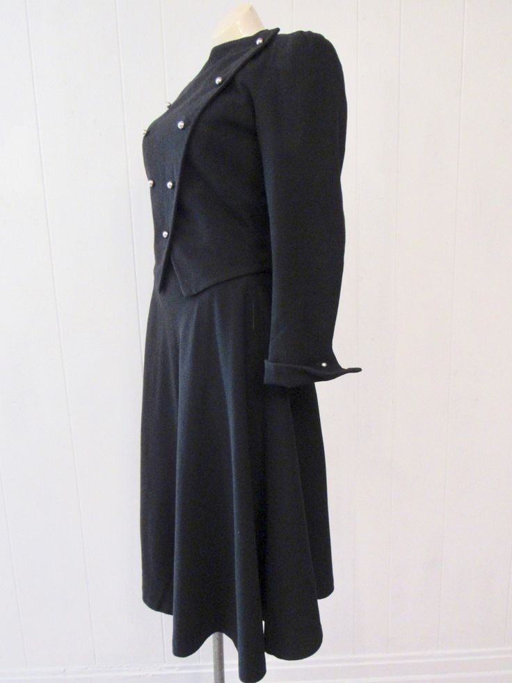 "Vintage 1940s women's suit, jacket and skirt. Made of black rayon/wool. Double breasted military or riding style. Has chrome ball buttons, short cropped, full skirt and pointed turned up cuffs with functional button. Quality construction. No label. Size small. Actual measurements of the jacket: Bust: 34\" waist: 28\" Shoulder seam to shoulder seam: 15.5\" Shoulder seam to cuff: 21.5\" Overall length: 21\" Skirt: waist: 23\" hips: 44\" length: 30\" In excellent condition." Semi-formal Uniform Style Fitted Blazer, Semi-formal Fitted Uniform Style Blazer, Semi-formal Fitted Uniform Blazer, Fitted Uniform Style Blazer For Semi-formal Occasions, Black Fitted Uniform Style Blazer, Classic Fitted Blazer For Costume, Fitted Classic Blazer For Costume, Formal Fitted Blazer With Epaulettes, Fitted Skirt Suit With Button Closure For Fall