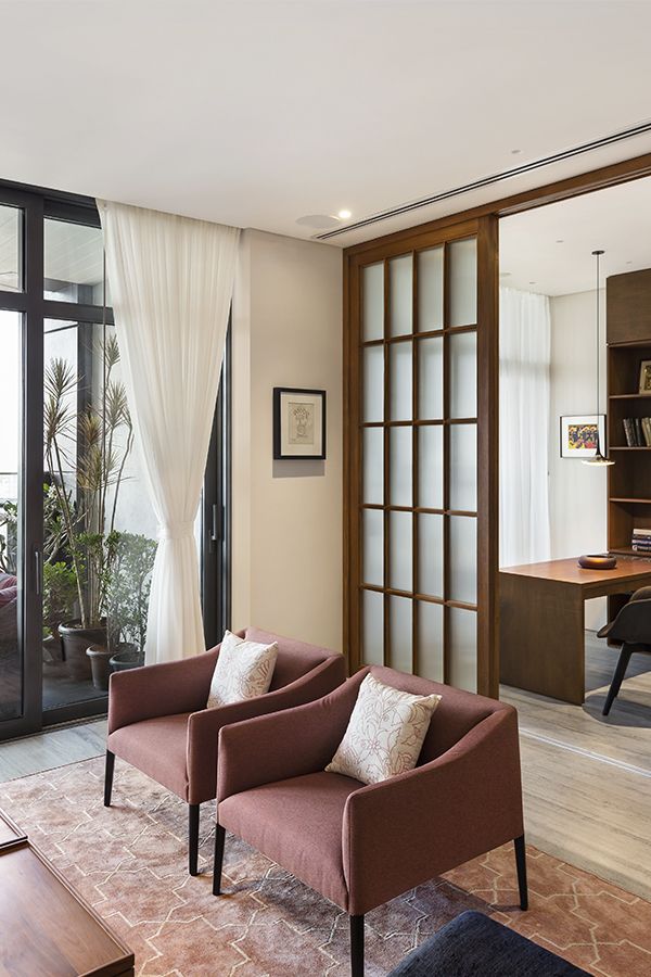 a living room filled with furniture next to a large glass door leading to a balcony