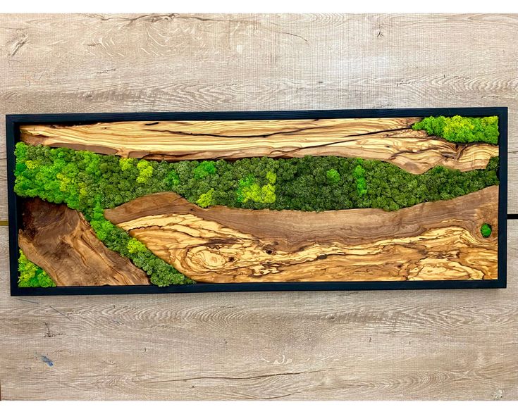 a wood panel with green trees on it