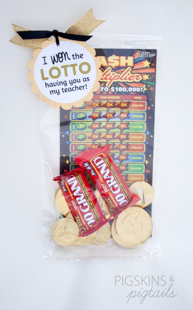 a bag of chips and crackers sitting on top of a white tablecloth next to a sign that says i run the lotto