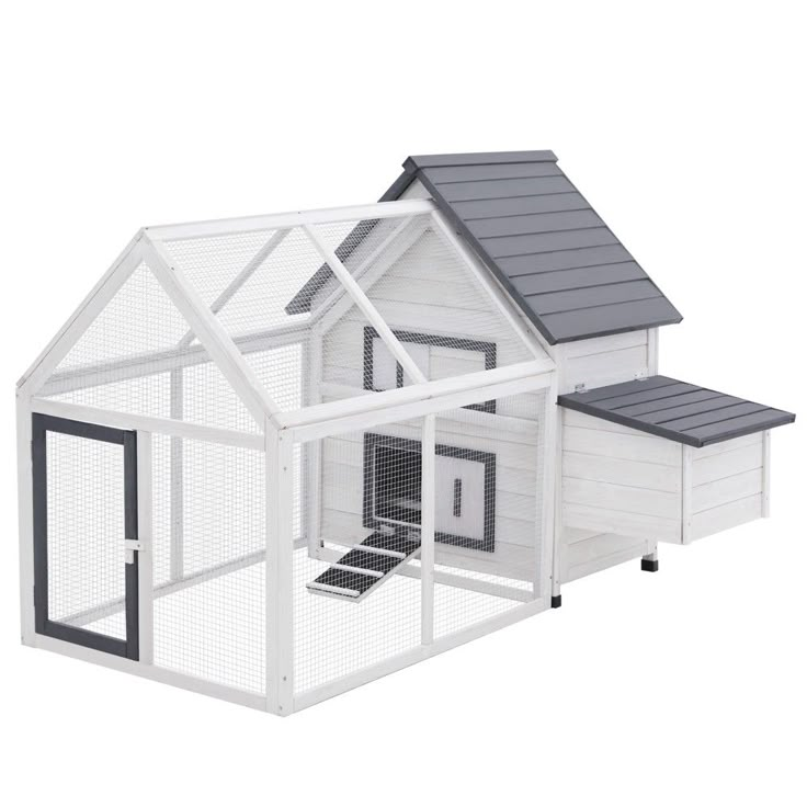 a white chicken coop with a gray roof and black trim on the top half of it