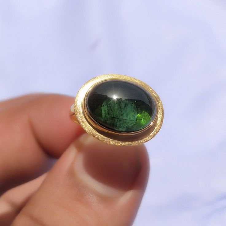 Cabochon Ring Green Tourmaline-14k Gold Cabochon Ring-Tourmaline Ring Women-18k Gold Ring-Statement Ring-Vintage Ring-October birthstone About Ring:- Gemstone = Green Tourmaline  Cabochon Lab [ If You Want Natural Tourmaline Cabochon Just Please message me For Have it At a reasonable Price.]  Gemstone Shape = Oval Cabochon ------------------------------------------------------------------------------------------------------------------------------------------------- Fast Shipping: It will take 1 Oval Tourmaline Emerald Ring In Yellow Gold, Gold Tourmaline Rings, Tourmaline Birthstone Ring With Bezel Setting, Yellow Gold Tourmaline Cabochon Ring, Classic Oval Tourmaline Emerald Ring, Formal Round Tourmaline Birthstone Ring, Oval Tourmaline Emerald Ring For Anniversary, Oval Tourmaline Ring For May Birthstone, Oval Tourmaline Emerald Ring With Bezel Setting