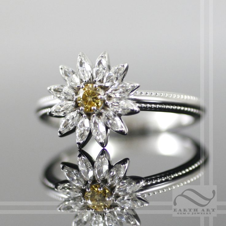 two wedding rings with yellow and white diamonds on top of each other's shoulders