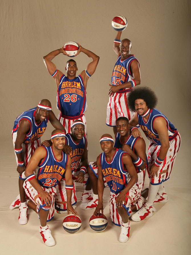 a group of basketball players pose for a team photo in red, white and blue uniforms