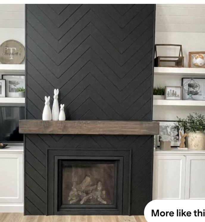 a fireplace with white vases on top of it and shelves above the fire place