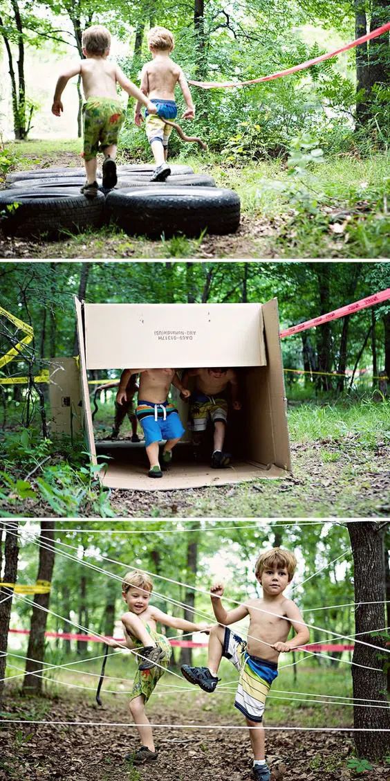 two young boys playing in the woods with their trunks on and one holding onto a rope