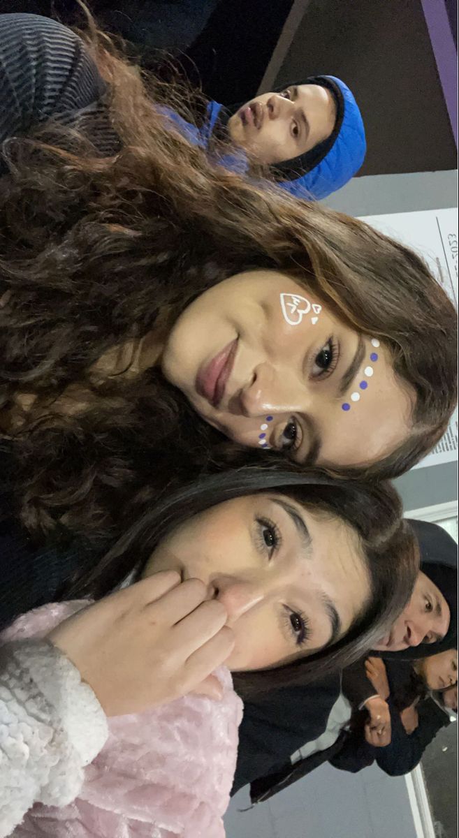 three young women standing next to each other