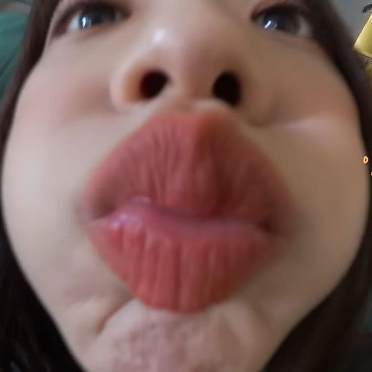 a close up of a person with their tongue hanging out to the side and her mouth open