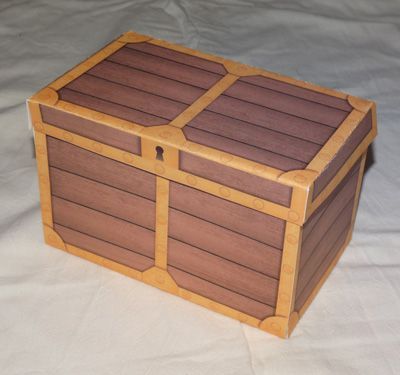 a large wooden box sitting on top of a white sheet