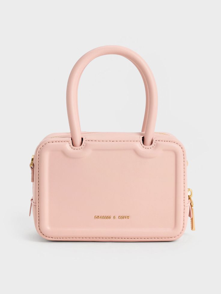 This product is made with at least 20% sustainable materials by weight. CHARLES & KEITH uses recycled, degradable, organic, and water-based materials in our eco-conscious collection.If a dainty, polished carrier is what you are looking for, then the Perline tote is your best bet. The angular boxy shape is softened by the charming pink finish, creating a minimalist yet unmistakably feminine silhouette. Affixed with classic top handles, the structured carrier is elevated enough for evening functio Charles And Keith Bags, Charles And Keith, Luxury Bags Collection, Size Chart For Kids, Charles Keith, Airport Fashion, Printables Kids, Handle Bag, Sustainable Materials