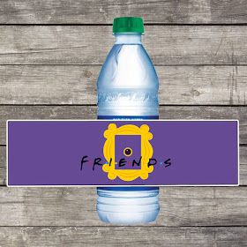 a bottle of water sitting on top of a wooden table next to a sign that says friends