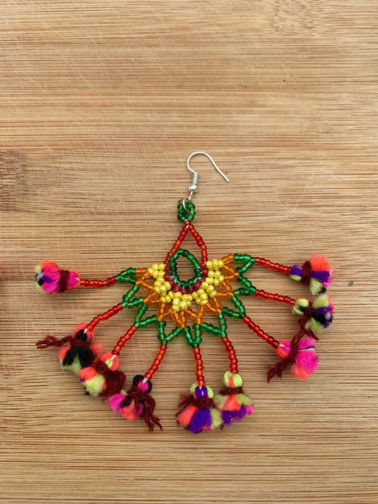 Kalbeliya Gypsy Tribal Necklaces- Mirabelle Handmade Kalbeliya earrings with sterling silver posts in glorious color combos of beaded work and tassels. These bold beauties mimic the flamboyancy of the Kalbeliya tribal people. Each pair is made by a woman, a dancer from the tribe, named Moriya. She makes each piece with love and an eagerness to demonstrate a taste of her culture. Kalbeliya tribe people are known for snake charming and trading snake venom. They are also called Saperas or Snake Cha Traditional Festive Beaded Earrings With Colorful Beads, Adjustable Dangle Beaded Earrings For Festivals, Festival Chandelier Drop Earrings With Dangling Beads, Bohemian Beaded Dangling Earrings For Festivals, Bohemian Beaded Earrings With Dangling Beads For Festivals, Dangle Tassel Jewelry For Festival, Festival Gift Jewelry With Tassels, Celebration Jewelry With Tassels, Traditional Beaded Tassel Earrings As Gift