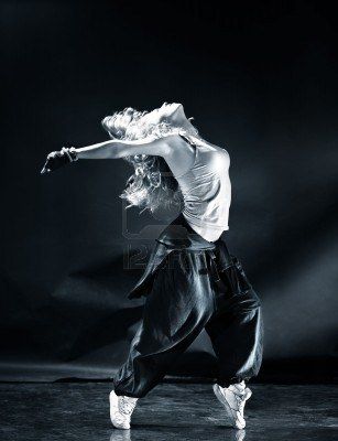 a woman in white shirt and black pants dancing