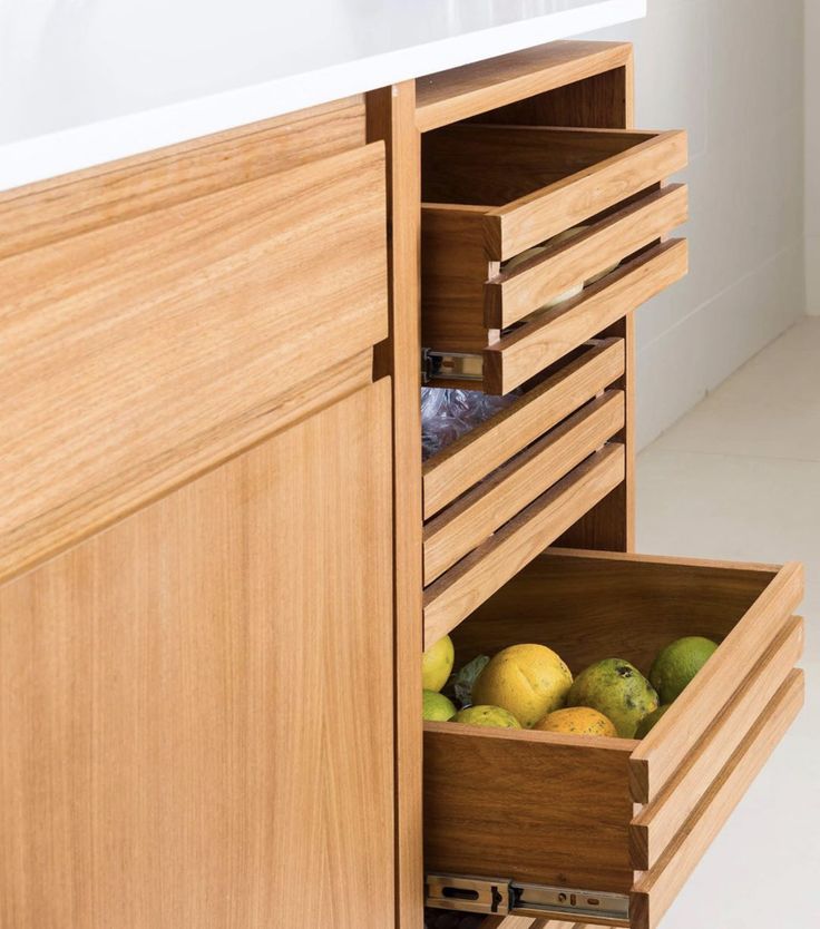 a wooden cabinet with drawers filled with fruit